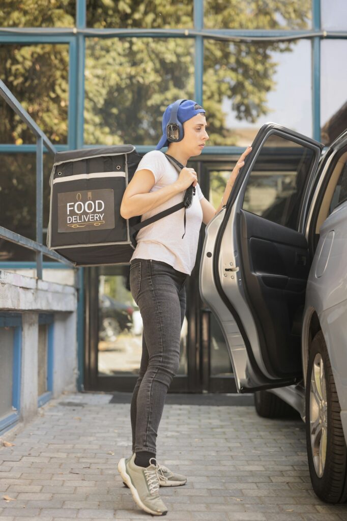 Takeaway food delivery courier delivering office lunch by car